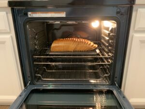 Place loaf of bread on baking sheet in the oven.